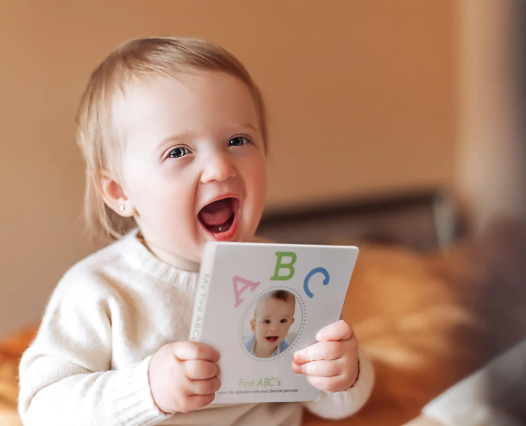 Baby chewing a custom made ABC Board Book